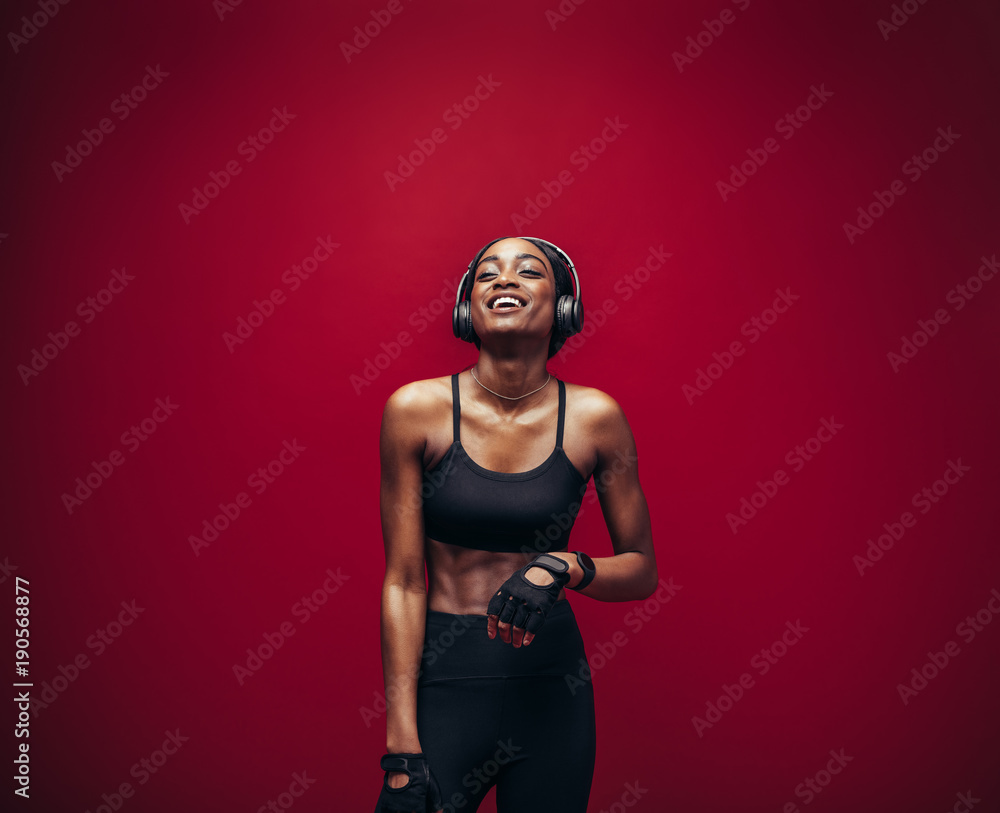 Fitness woman relaxing and listening music after her workout