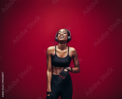 Fitness woman relaxing and listening music after her workout