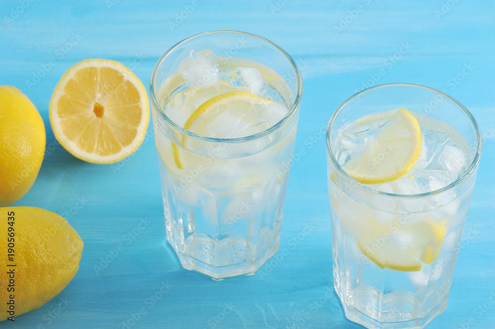 homemade lemonade - lemon, ice and water in glasses homemade lemonade - lemon, ice and water in glasses