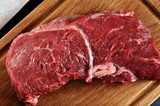 red raw beef steak on a wooden Board