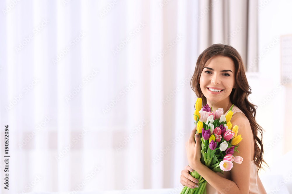 Beautiful woman with bouquet of tulips at home Beautiful woman with bouquet of tulips at home