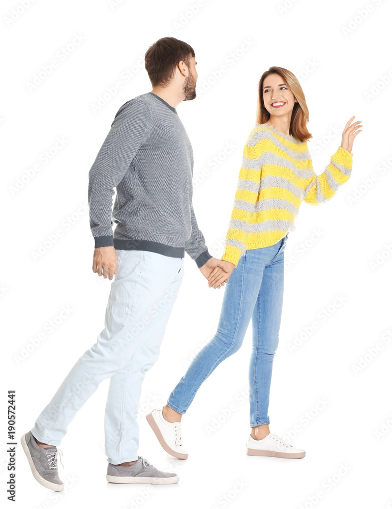 Young couple in casual clothes walking on white background Young couple in casual clothes walking on white background