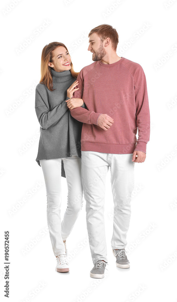 Young couple in casual clothes walking on white background Young couple in casual clothes walking on white background