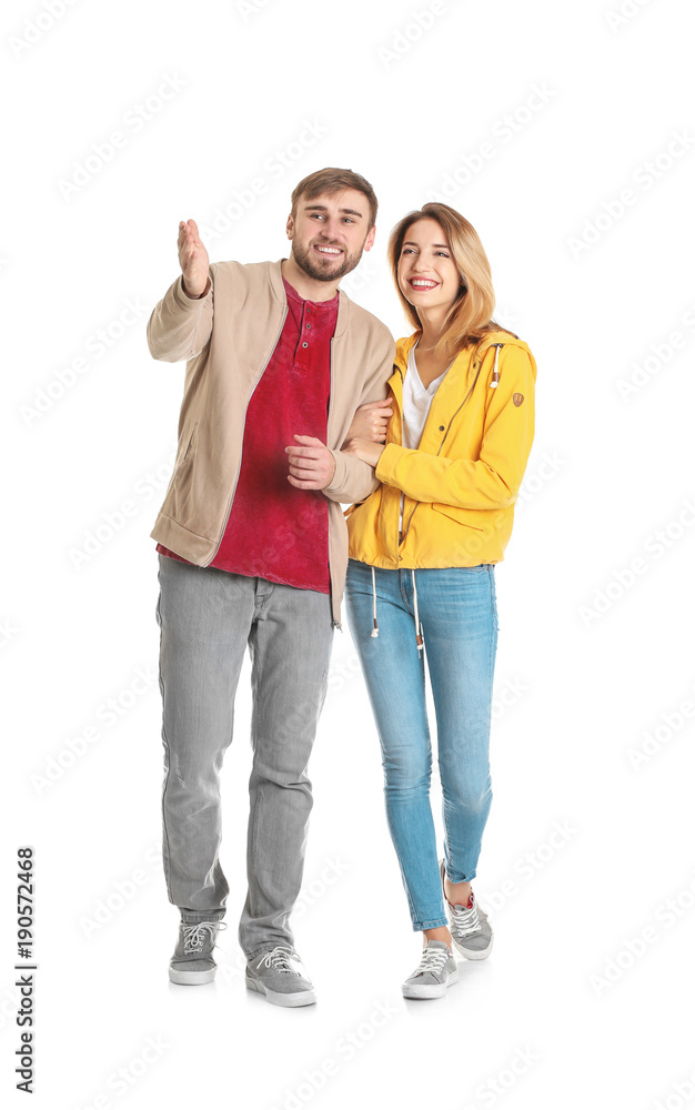 Young couple in casual clothes walking on white background Young couple in casual clothes walking on white background