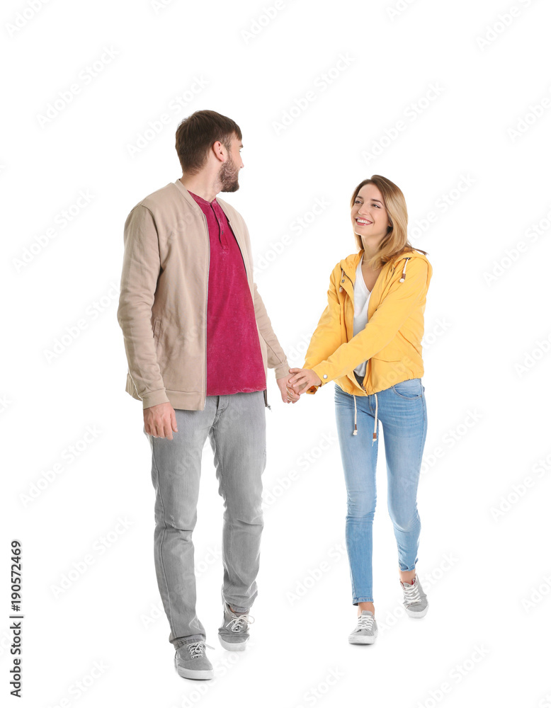 Young couple in casual clothes walking on white background Young couple in casual clothes walking on white background