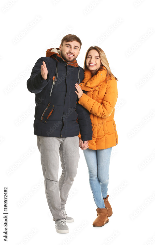 Young couple in casual clothes walking on white background
