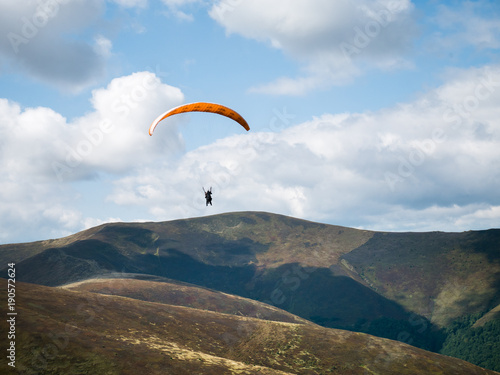 Stunning mountain landscape with Paraglider. The mountain range in the Carpathians. View from the mountain Gemba, (Pylypets, Zakarpatska oblast, Ukraine)