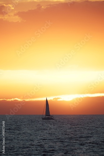 Beautiful sunset at the sea with sailing boat