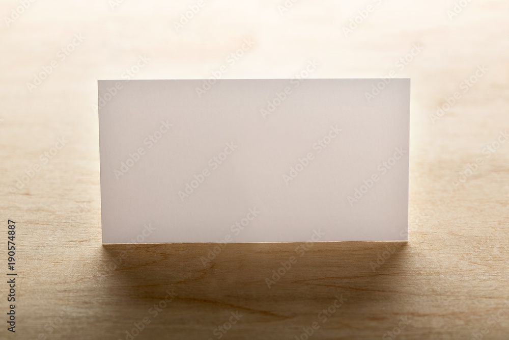 Blank business cards on a wooden surface Blank business cards on a wooden surface