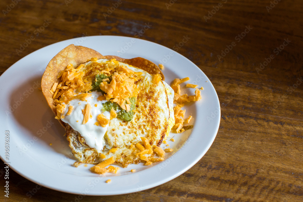 fried eggs with cheese and sour cream