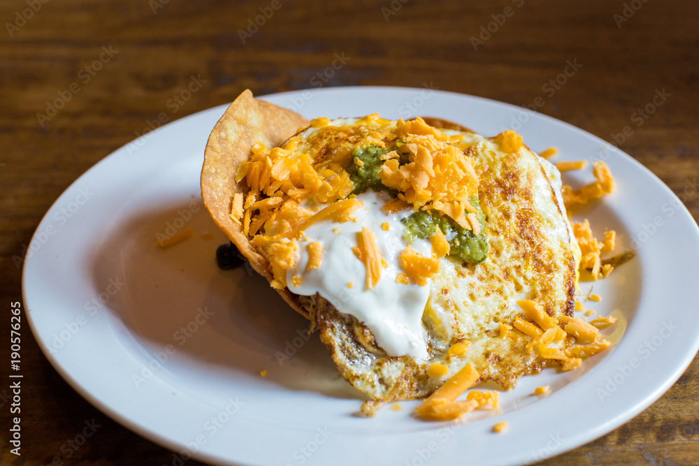 fried eggs with cheese and sour cream