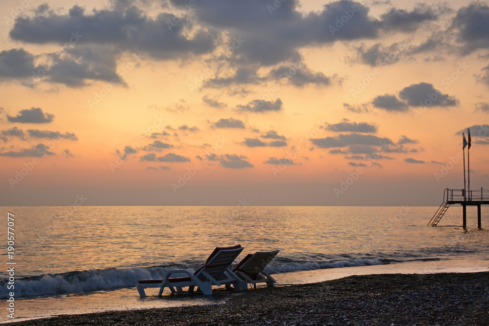 Beach chair by the sea at sunset. Romantic mood Beach chair by the sea at sunset. Romantic mood
