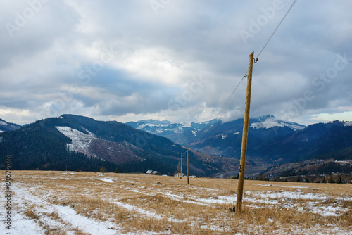 Wooden pillars - electric grids in the winter Carpathian mountai