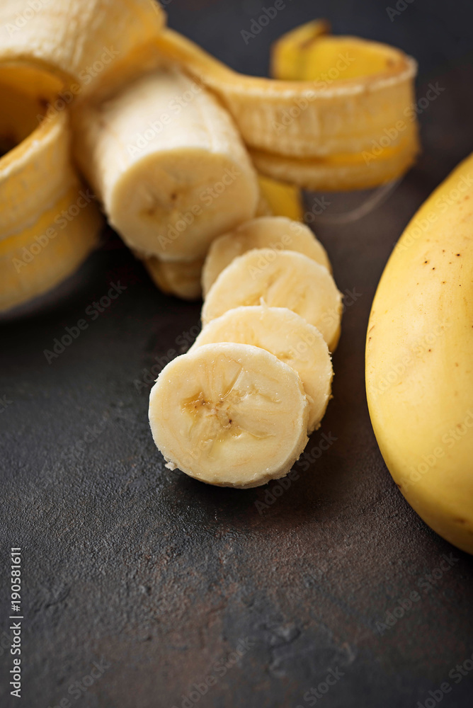 Fresh sliced banana on dark background Fresh sliced banana on dark background