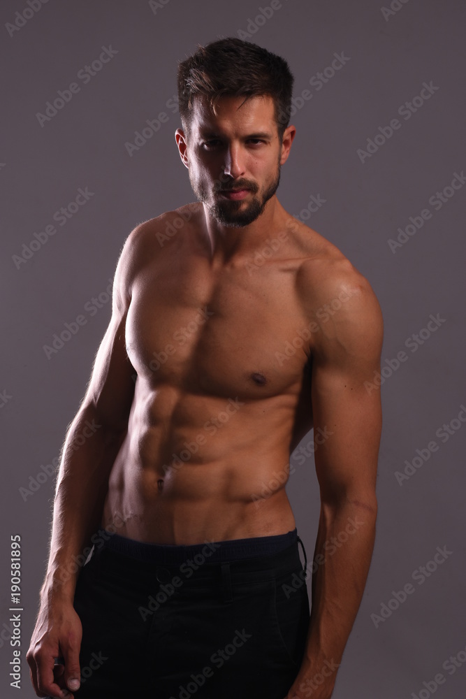 Shirtless athlete posing with flexing Abs Shirtless athlete posing with flexing Abs