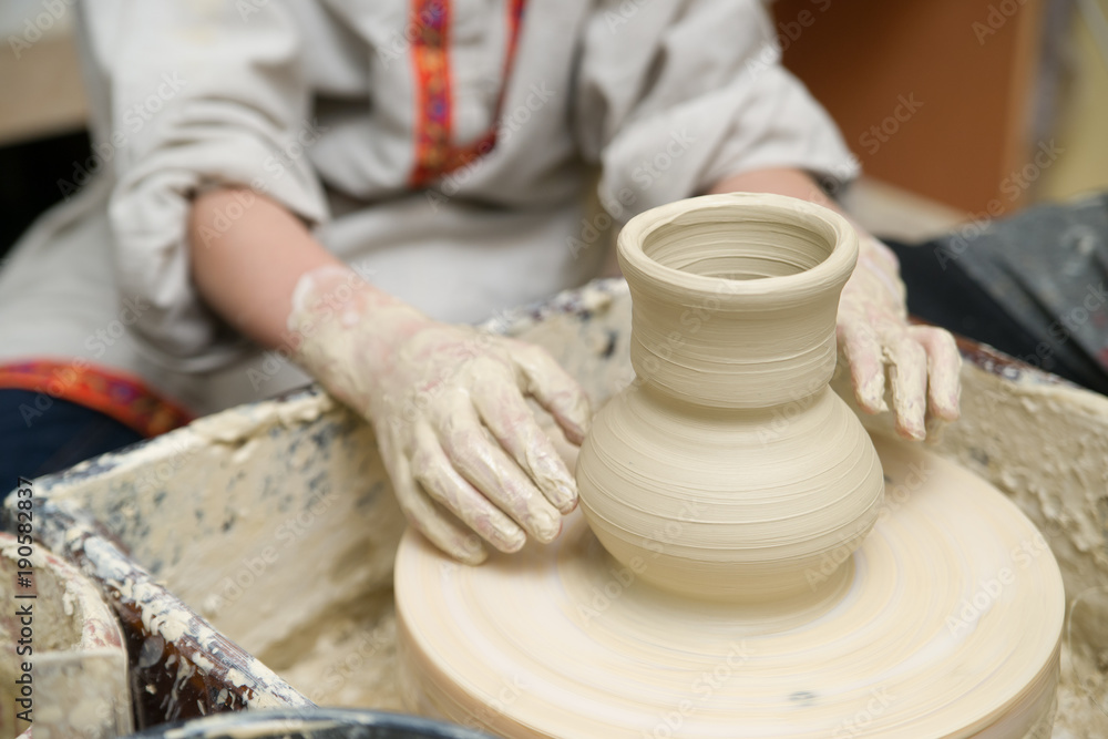 Hands of young potter kneading clay Hands of young potter kneading clay