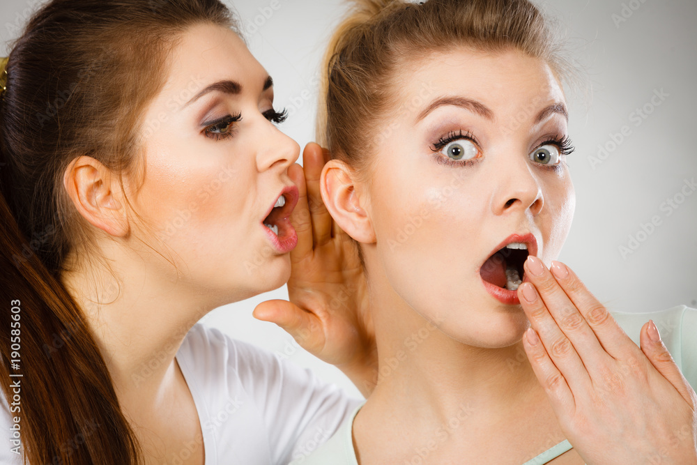 Two women telling gossip Two women telling gossip