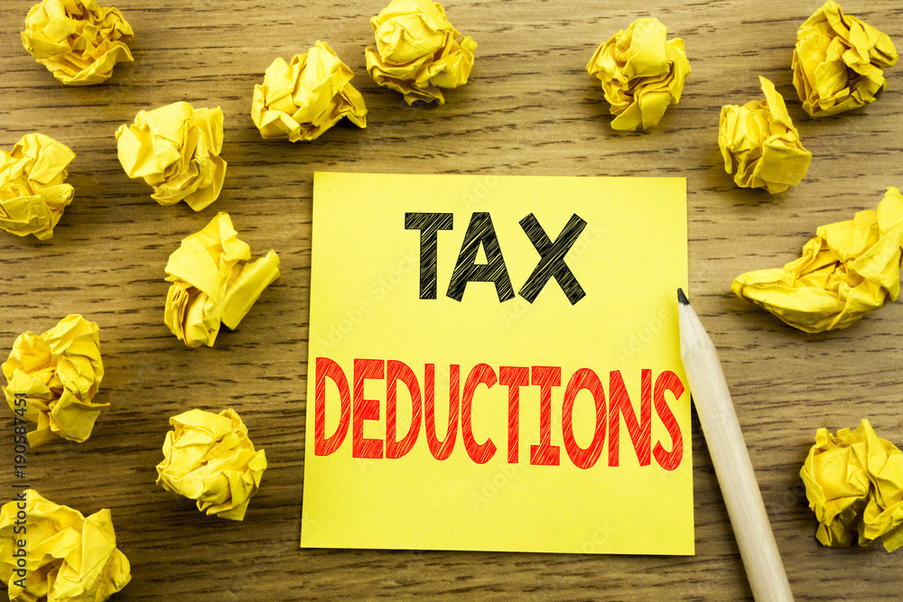 Naklejka premium Word, writing Tax Deductions. Business concept for Finance Incoming Tax Money Deduction written on sticky note paper on the wooden background. Folded yellow papers on the background