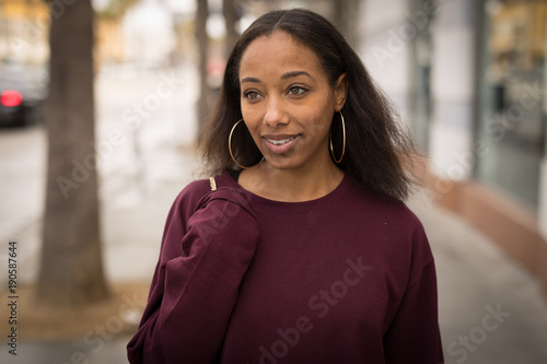 Young black woman walking street smile face