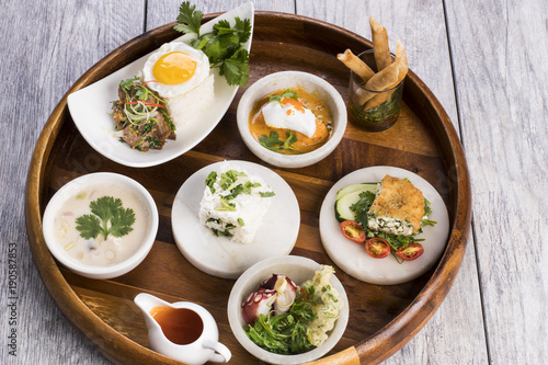 Assorted Thai food on wooden platter