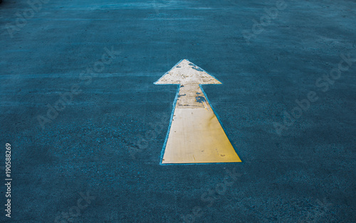 Asphalt road yellow marking. Direction arrow.forwarded yellow arrow on the road