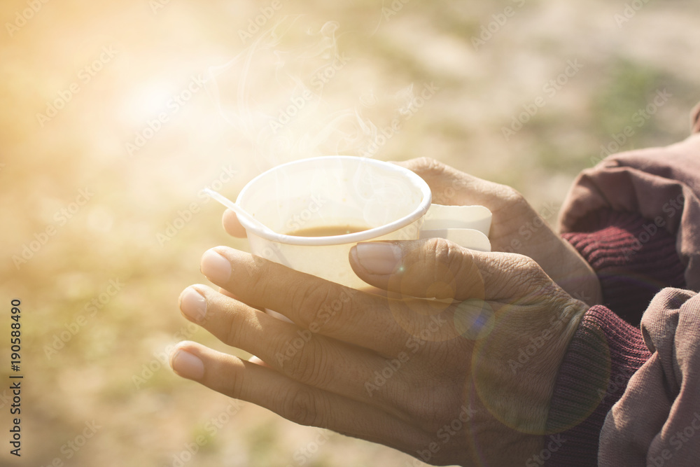 Good morning coffee in a paper cup in the hands of men in winter. Good morning coffee in a paper cup in the hands of men in winter.