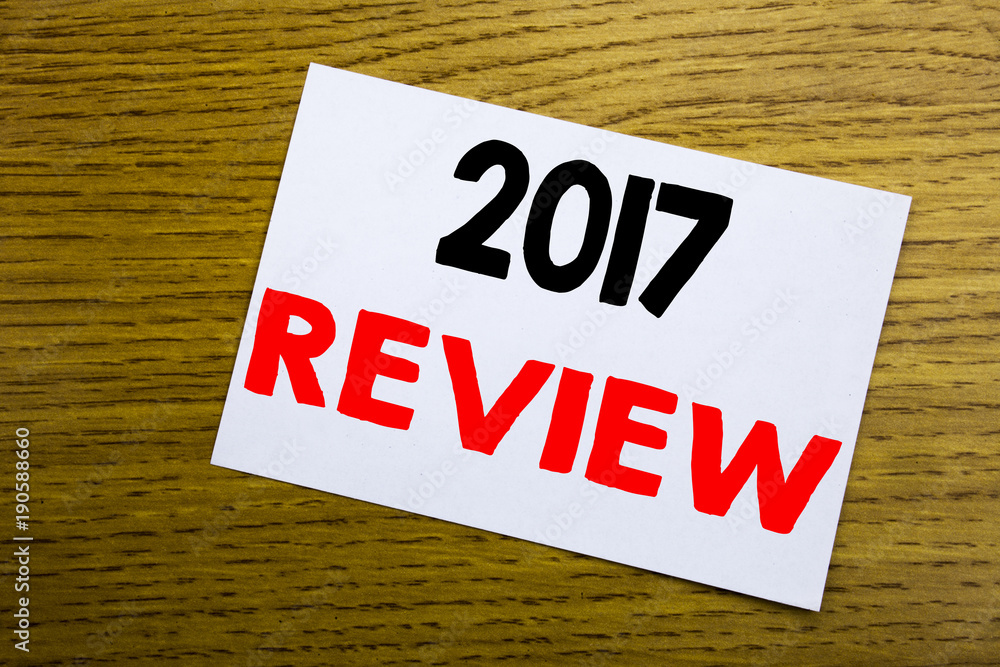 2017 Review. Business concept for Annual Summary Report written on sticky note, wooden wood background with copy space. 2017 Review. Business concept for Annual Summary Report written on sticky note, wooden wood background with copy space.