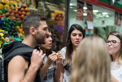 Friends Eating and Having Fun on Fruit Market in Municipal Market (Mercado Municipal) in Sao Paulo, Brazil