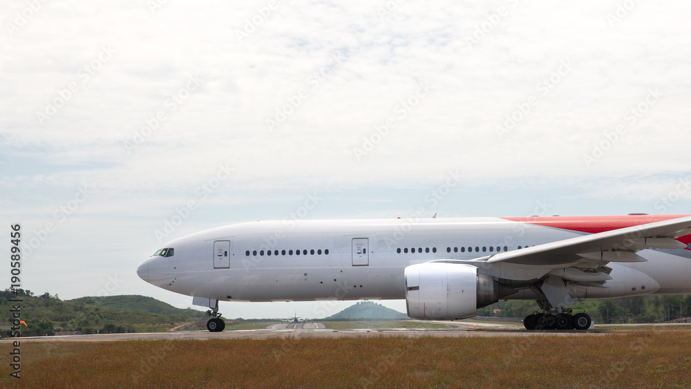 White airplane is taxiing to take off on sunny day / wide-body aircraft on  the runway