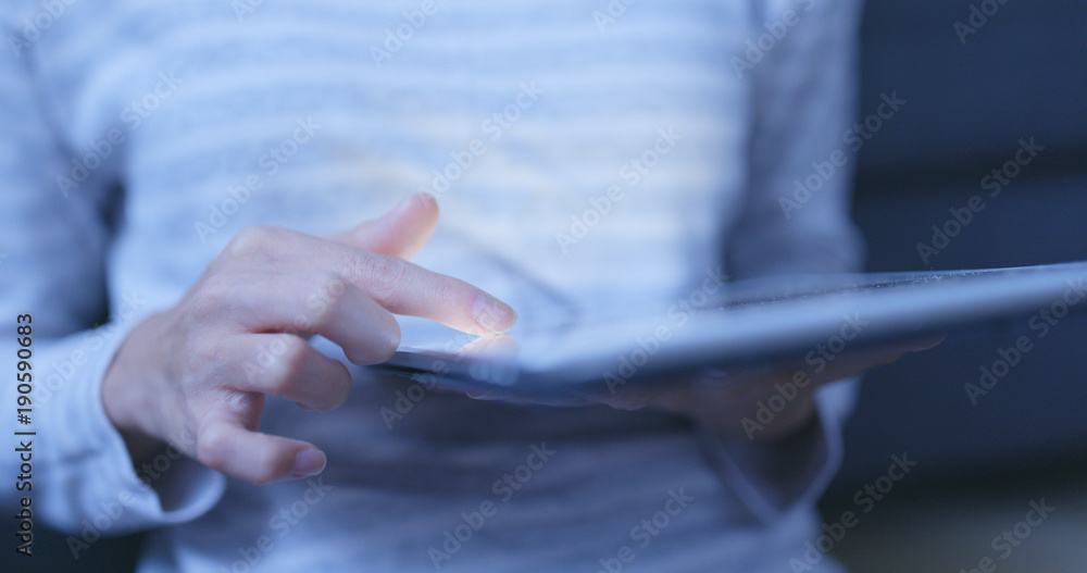 Woman use of digital tablet computer at night Woman use of digital tablet computer at night