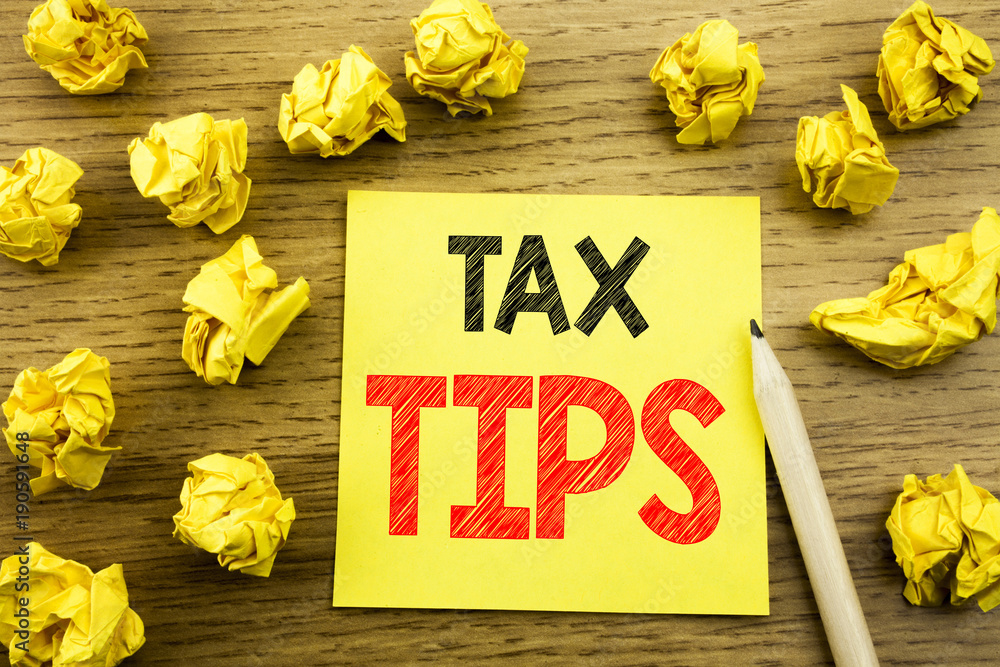 Fototapeta premium Word, writing Tax Tips. Business concept for Taxpayer Assistance Refund Reimbursement written on sticky note paper on the wooden background. Folded yellow papers on the background