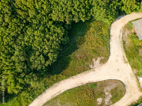 Drone photo of trees and a sandy pathway