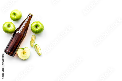 Apple cider. Low-alcoholic beveradge in dark bottle on white background top view copy space photo