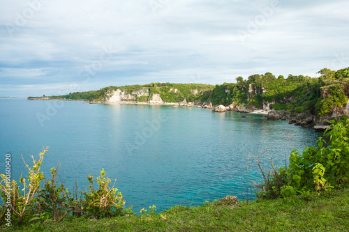 beautiful scenery of green hill with blue ocean