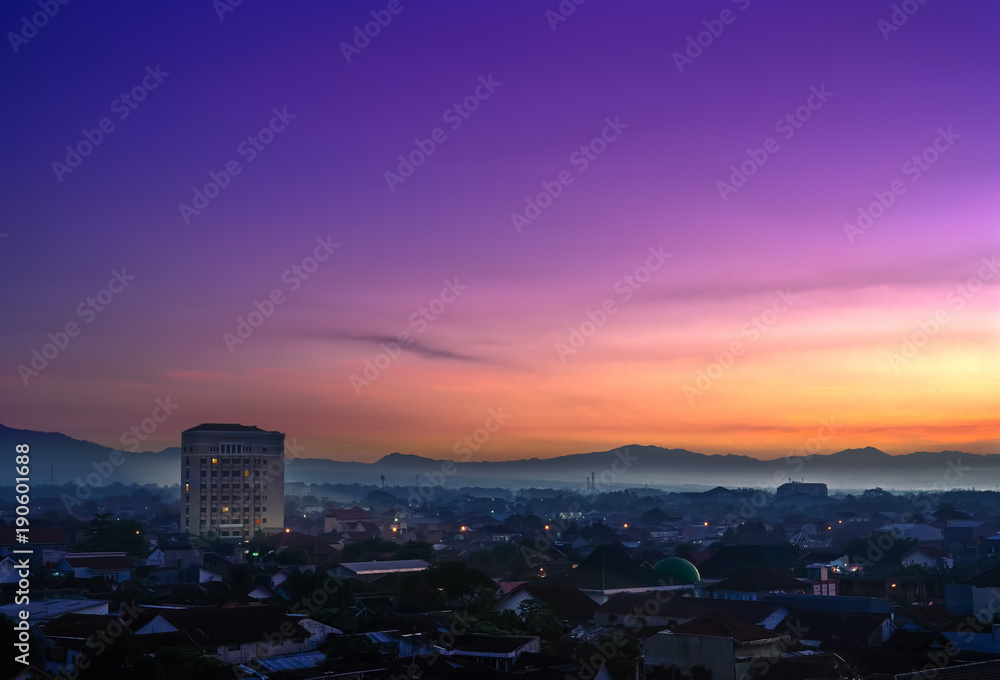 Landmark of Purwokerto city in Banyumas regency, Central Java at dawn before sunrise. Cityscape aerial view in misty morning