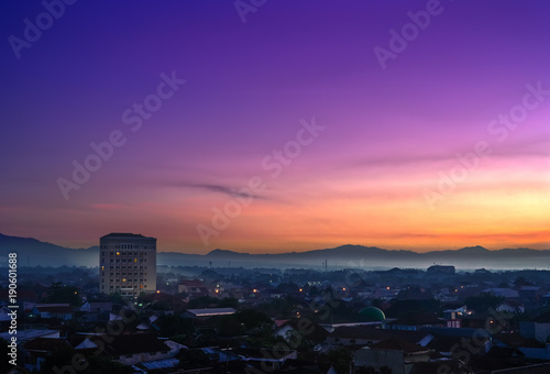 Landmark of Purwokerto city in Banyumas regency, Central Java at dawn before sunrise. Cityscape aerial view in misty morning