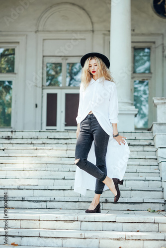 Girl is posing on the stone steps