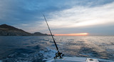 Sunrise view of fishing rod on charter fishing boat on the Pacific side of Cabo San Lucas in Baja Mexico BCS