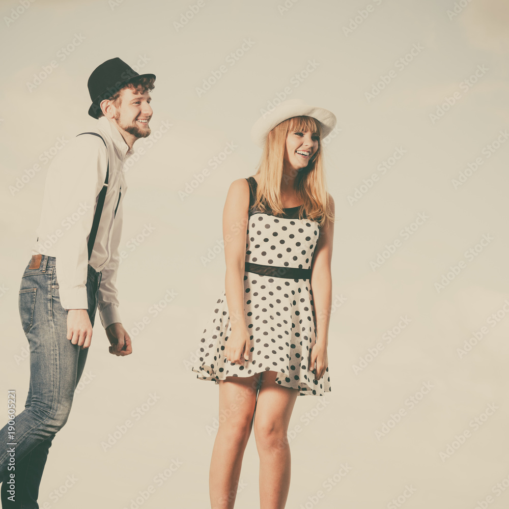 Loving couple retro style dating on sea coast Loving couple retro style dating on sea coast