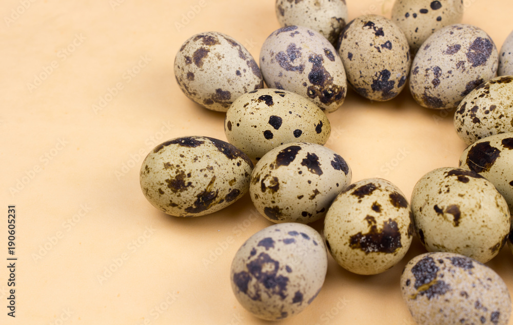 Quail eggs on pastel yellow surface. Close up macro. Easter holiday background. Quail eggs on pastel yellow surface. Close up macro. Easter holiday background.