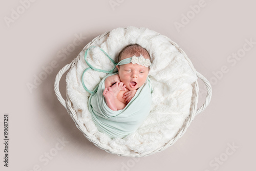 Little smiling baby in basket, top view