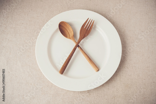 Bild auf Leinwand white plate with spoon and fork, Intermittent fasting concept, ketogenic diet, w
