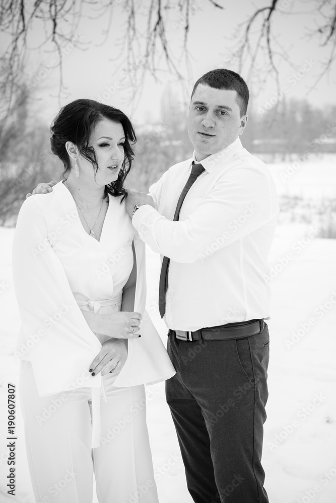 Happy Couple Having Fun and Embracing Outdoors in Snow Park. Winter magical time, Valentine day 14 february Happy Couple Having Fun and Embracing Outdoors in Snow Park. Winter magical time, Valentine day 14 february