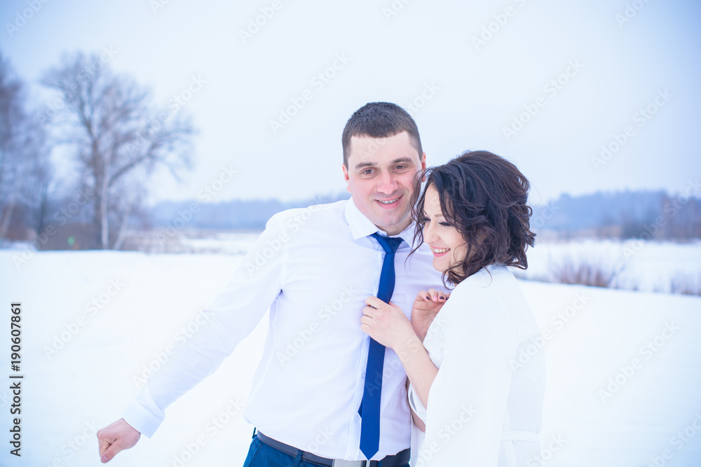 Happy Couple Having Fun and Embracing Outdoors in Snow Park. Winter magical time, Valentine day 14 february Happy Couple Having Fun and Embracing Outdoors in Snow Park. Winter magical time, Valentine day 14 february