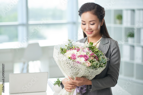 Happy business lady with flowers