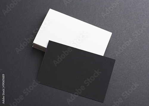 Black and white business card on black background. Mockup.