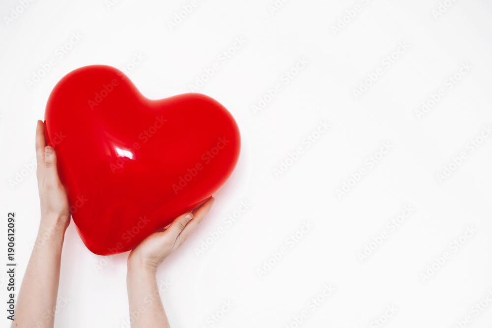 hands holding heart. happy valentine's day concept. red heart balloon on white background with space for text. health care, medicine and blood donation concept. love and protection hands holding heart. happy valentine's day concept. red heart balloon on white background with space for text. health care, medicine and blood donation concept. love and protection