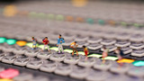 Miniature people : children and student on switcher control of Television Broadcast,color buttons.