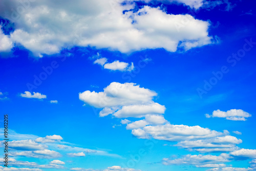 Beautiful white clouds in the blue sky. Summer landscape. © amarinchenko106
