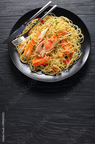 tasty spaghetti with Crab on black plate